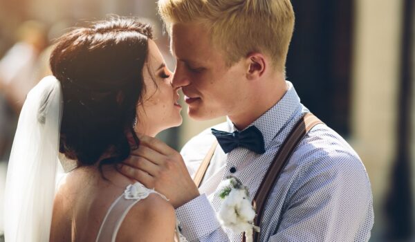 A bride and groom intimately touching foreheads