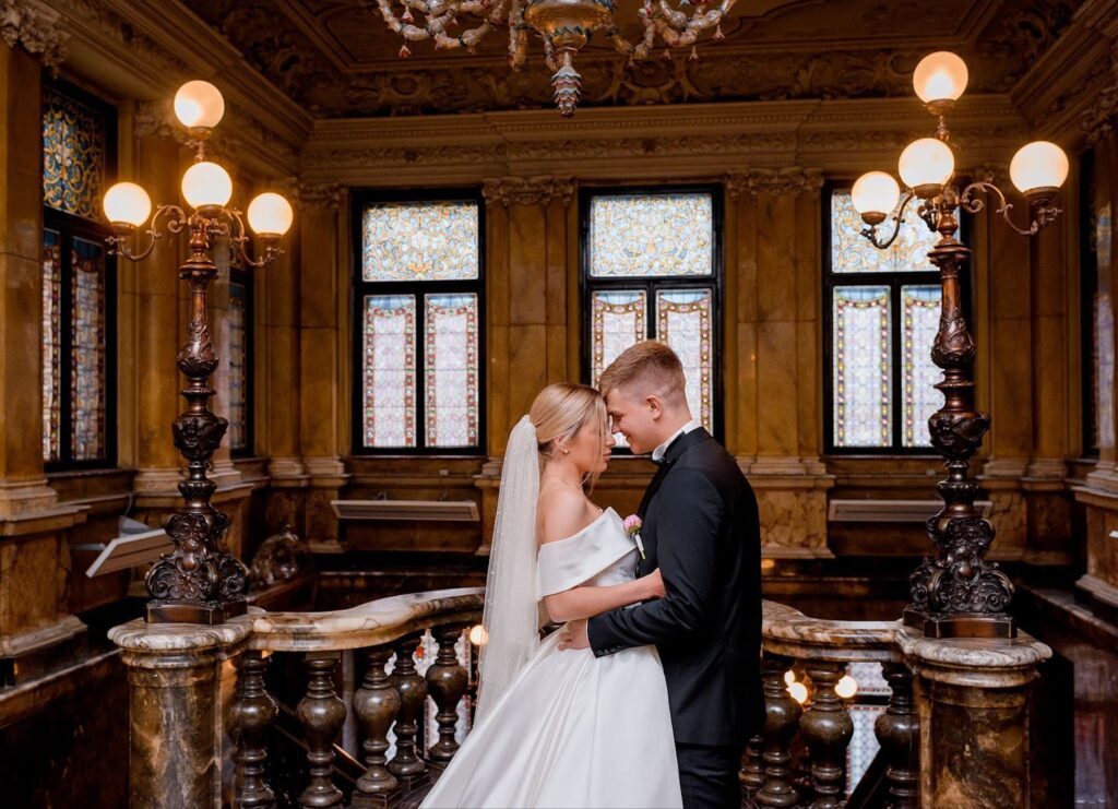 Groom and bride kissing in a beautiful building