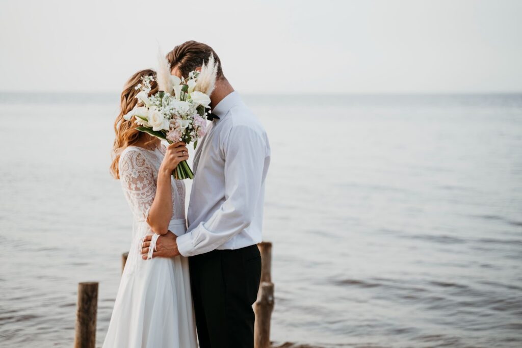Couple kissing and having their wedding at the beach