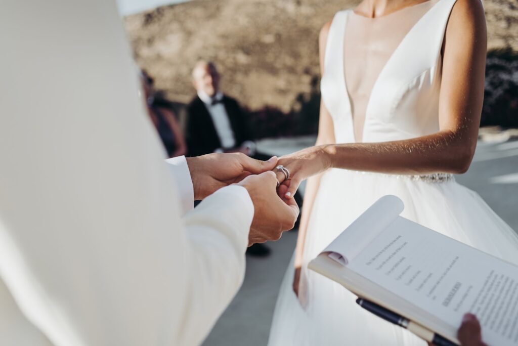 Bride and groom hold each other hands during the ceremony