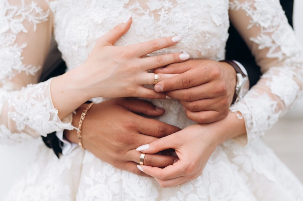 Groom and bride are putting on wedding rings