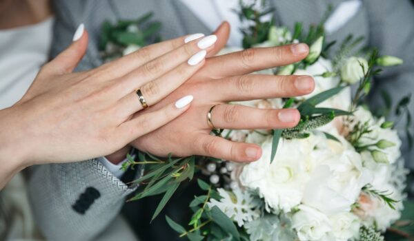 Close up of hands of a husband and wife on the day of their wedding