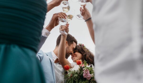 Low view of people celebrating with their friends getting married on the beach